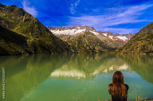 Women admire a beautiful mountain landscape with lake
