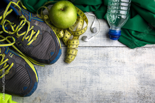 Sport stuff on wooden table, top view