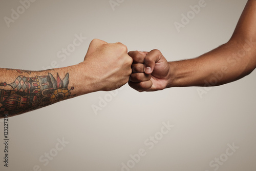 Wallpaper Mural Friends do a fist bump close up isolated on white Torontodigital.ca