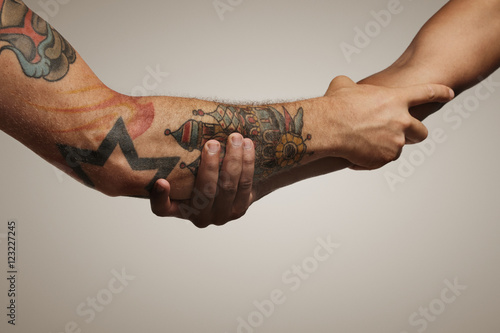 Photography Forearm shake of two young male friends isolated on white
