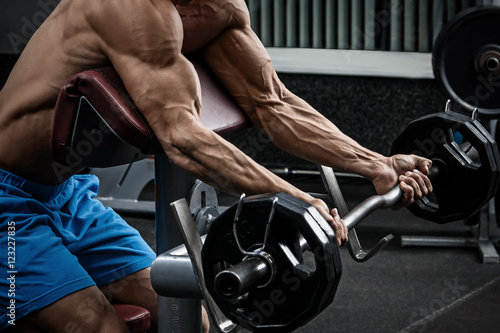 Muscular man training his arms