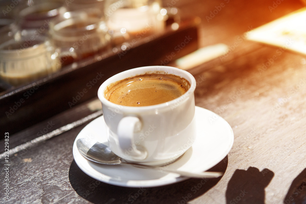 Coffee cup and coffee beans on table Coffee cup and coffee beans on table