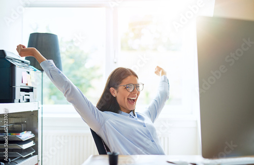Fotografie Joyous woman in small office with extended arms