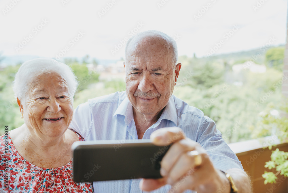 Happy senior couple taking a selfie with smartphone Happy senior couple taking a selfie with smartphone