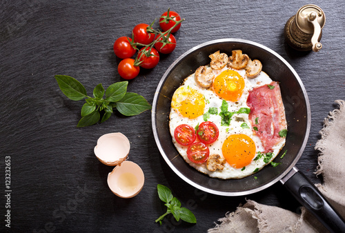 Fototapeta Naklejka Na Ścianę i Meble -  breakfast with fried eggs in a pan
