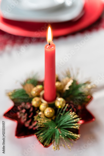 Close up on burning chrismas candle decoration - christmas, advent, celebration concept