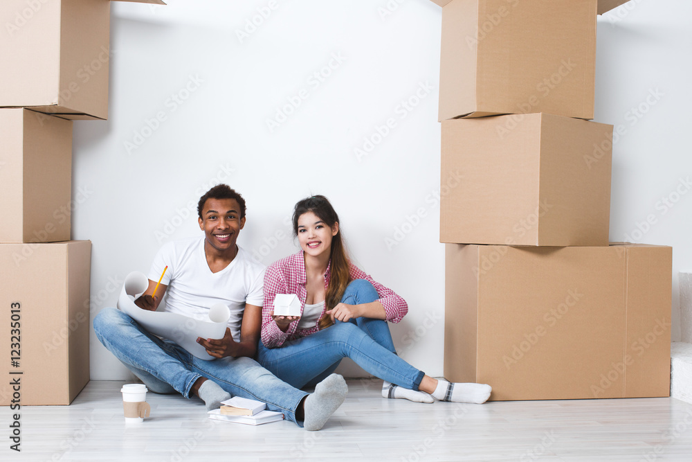 Couple sitting on the floor new house after moving. Couple sitting on the floor new house after moving.