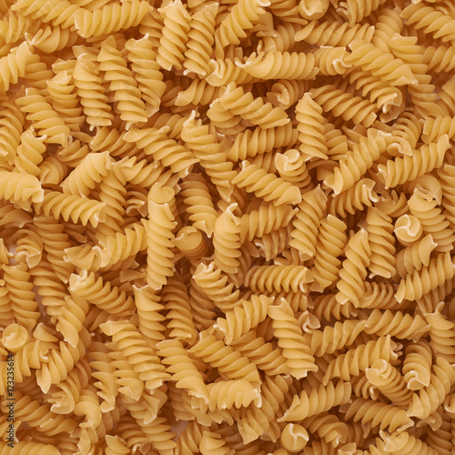 Pile of rotini yellow pasta as abstract background
