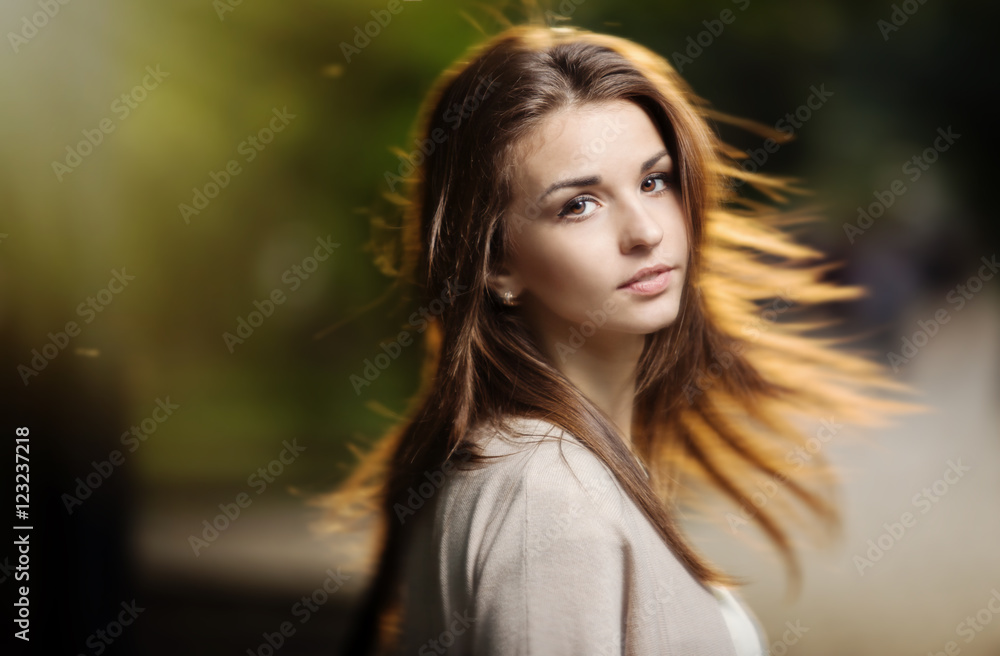 Portrait of beauty woman with perfect smile walking on the street and looking at camera, sunset light Portrait of beauty woman with perfect smile walking on the street and looking at camera, sunset light