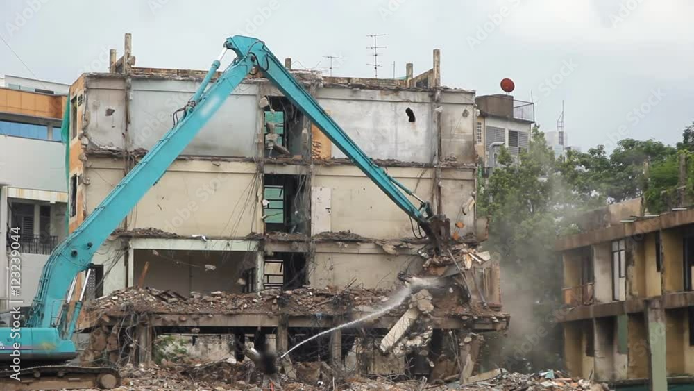 Excavator machinery working on demolition old building Excavator machinery working on demolition old building