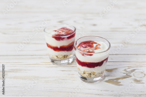 Homemade yogurt with berry jam and oat flakes
