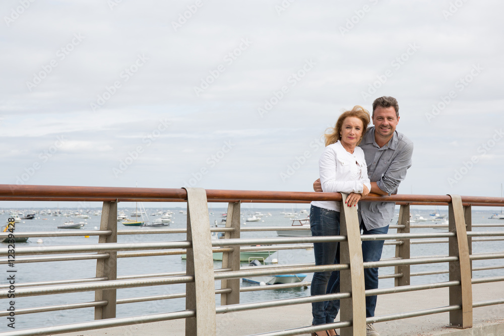 Happy young couple in love embracing on the bridge Happy young couple in love embracing on the bridge