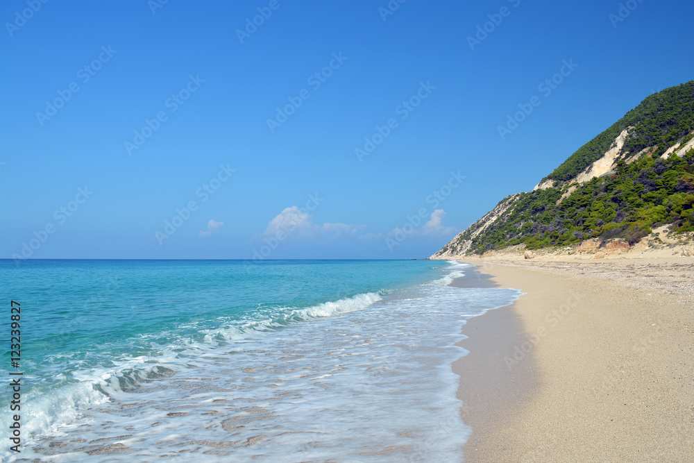 Secluded sandy beach in quiet sunny day with calm turquoise sea