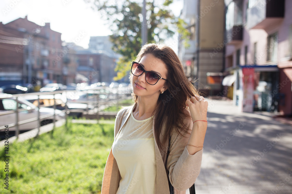 Young pretty woman outdoor fashion portrait. Beautiful girl casual dress and sunglasses