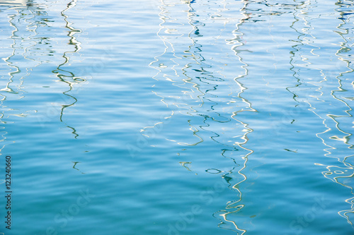 Boat masts reflection abstract in Italian waters. photo