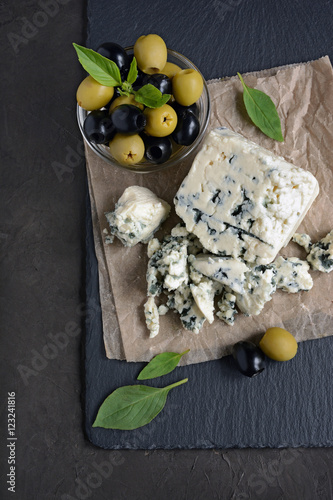 Blue cheese with black and green olive, basil and crispbread photo