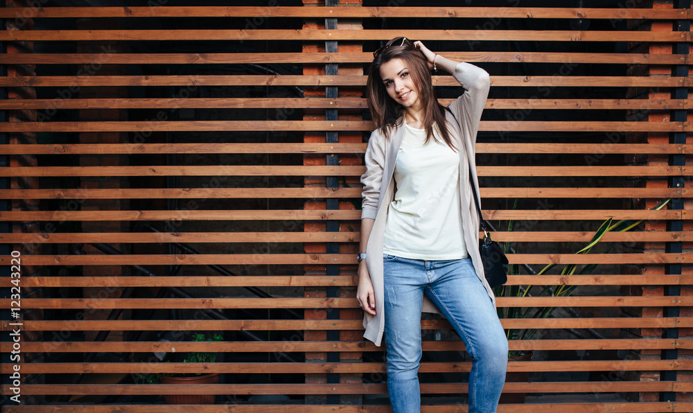Young beautiful happy woman in casual cloths against wall Young beautiful happy woman in casual cloths against wall
