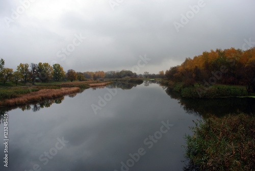 Autumn landscape, yellow trees on the river bank