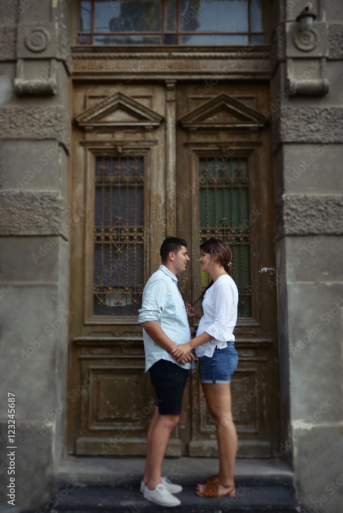 Couple siting in front of an old entrance