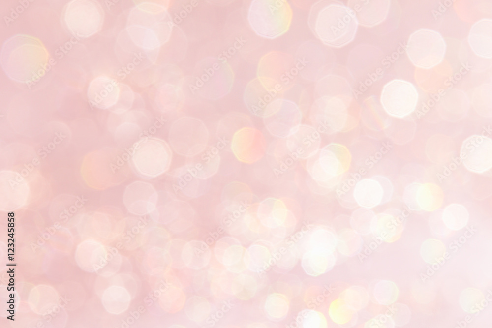 Bokeh soft pastel pink background with blurred golden lights. Festive background. Bokeh soft pastel pink background with blurred golden lights. Festive background.