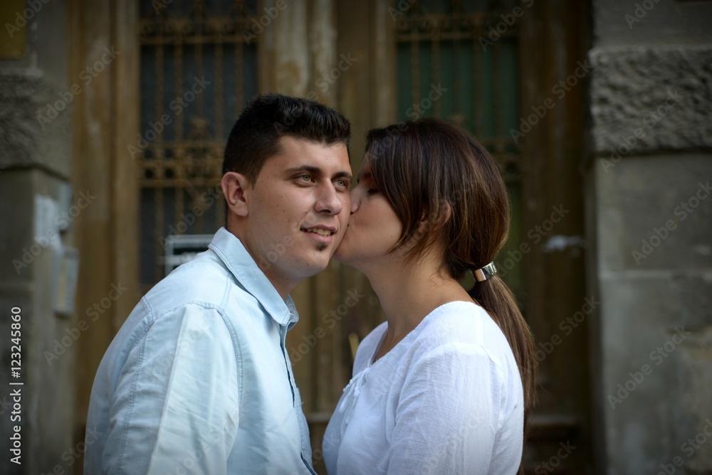 Couple siting in front of an old entrance Couple siting in front of an old entrance