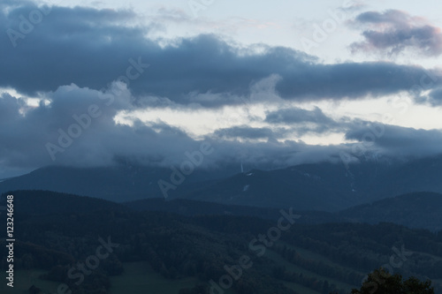 Summer landscape in mountains and the dark blue sky with clouds