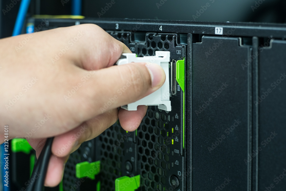 Close up hand connecting console cable to server Close up hand connecting console cable to server