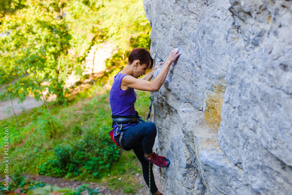 The girl climbs the rock. The girl climbs the rock.