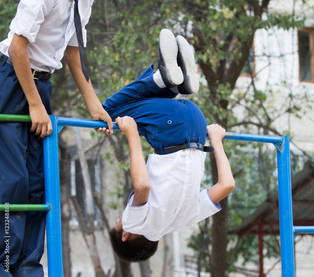 Fototapeta premium Boy training on a horizontal bar