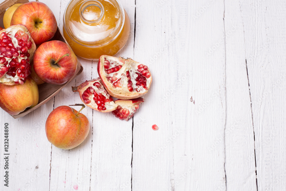 Pieces ripe pomegranate, honey and apple Pieces ripe pomegranate, honey and apple