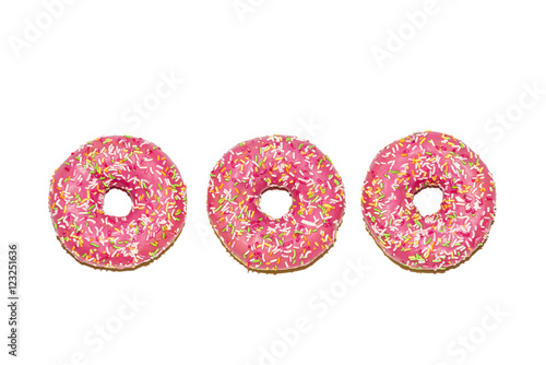 Three  glazed strawberry donuts on white background, top view