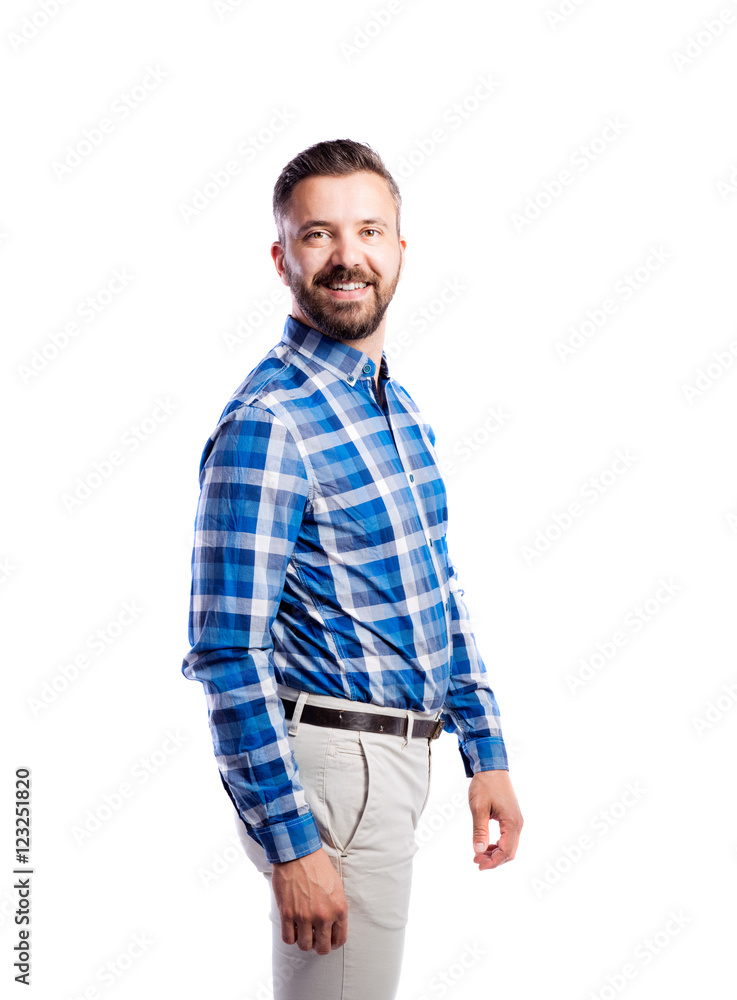 Hipster man in checked blue shirt, studio shot, isolated. Hipster man in checked blue shirt, studio shot, isolated.