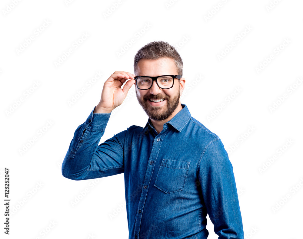Hipster man in blue denim shirt. Studio shot, isolated. Hipster man in blue denim shirt. Studio shot, isolated.