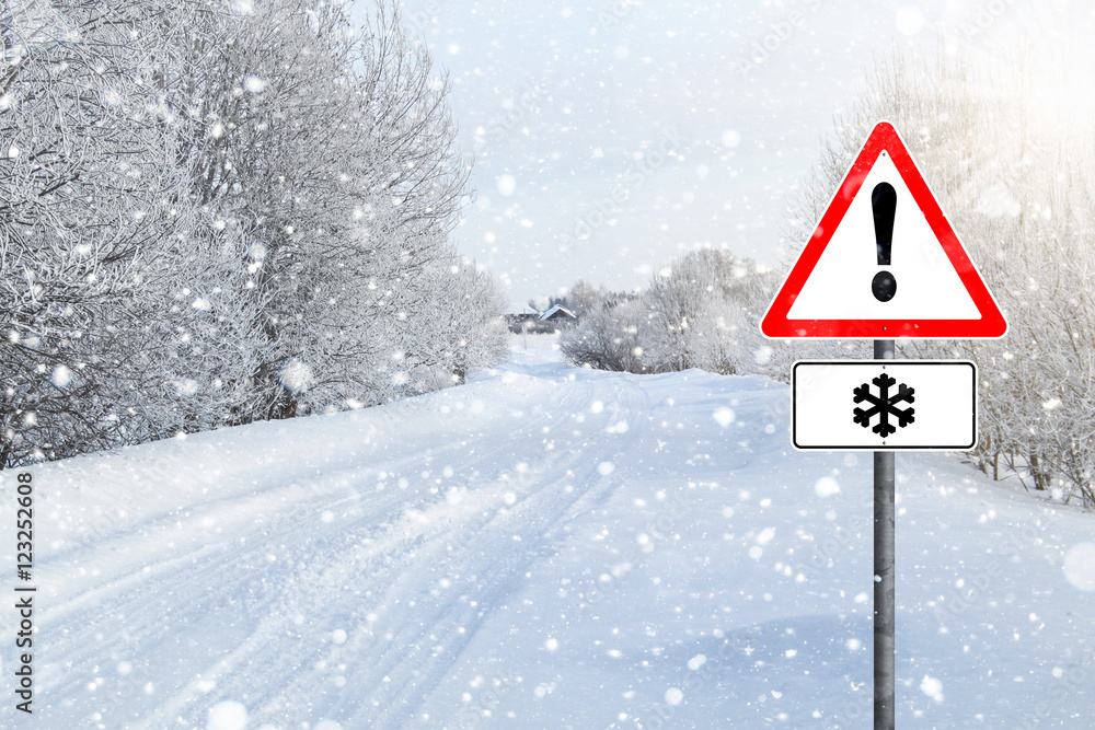 Empty winter road, road sign warning snowfall, Exclamation point, a lot of snow, snowfall, frost on branches. clean road asphalt Empty winter road, road sign warning snowfall, Exclamation point, a lot of snow, snowfall, frost on branches. clean road asphalt