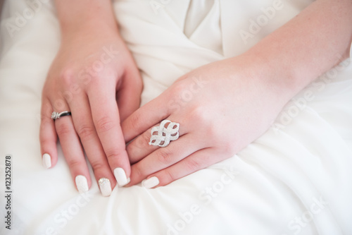 girl's hands with rings and nail polish