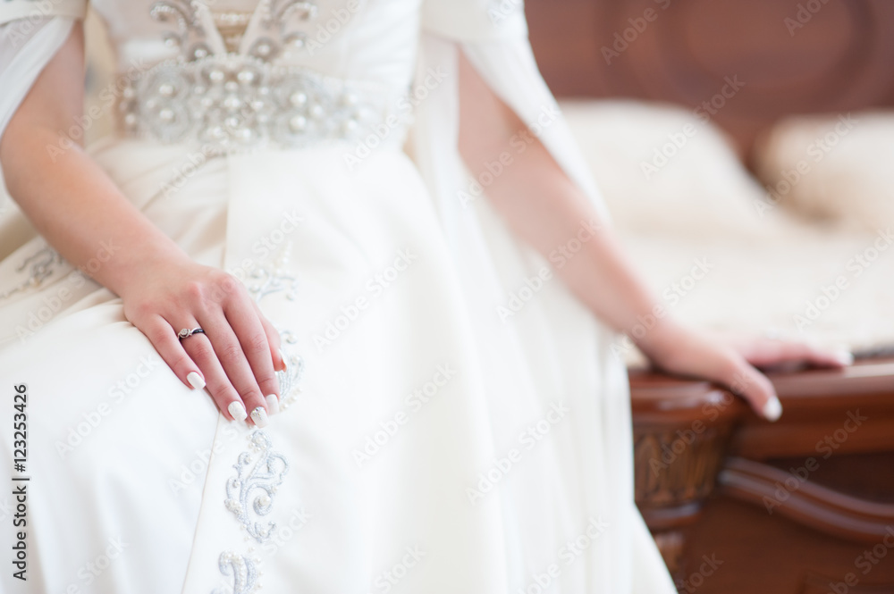 hands of bride in traditional caucasian dress