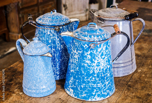 Antique granite-ware, speckle-ware, enamelware, agate-ware, coffee pots. Four pots in all. Two cobalt blue and white swirl, one grey and white mottled one light blue and white speckled.