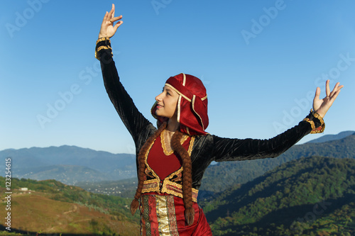 Konstfotografi young woman dancing georgian national clothes mountains outdoors summer sunny