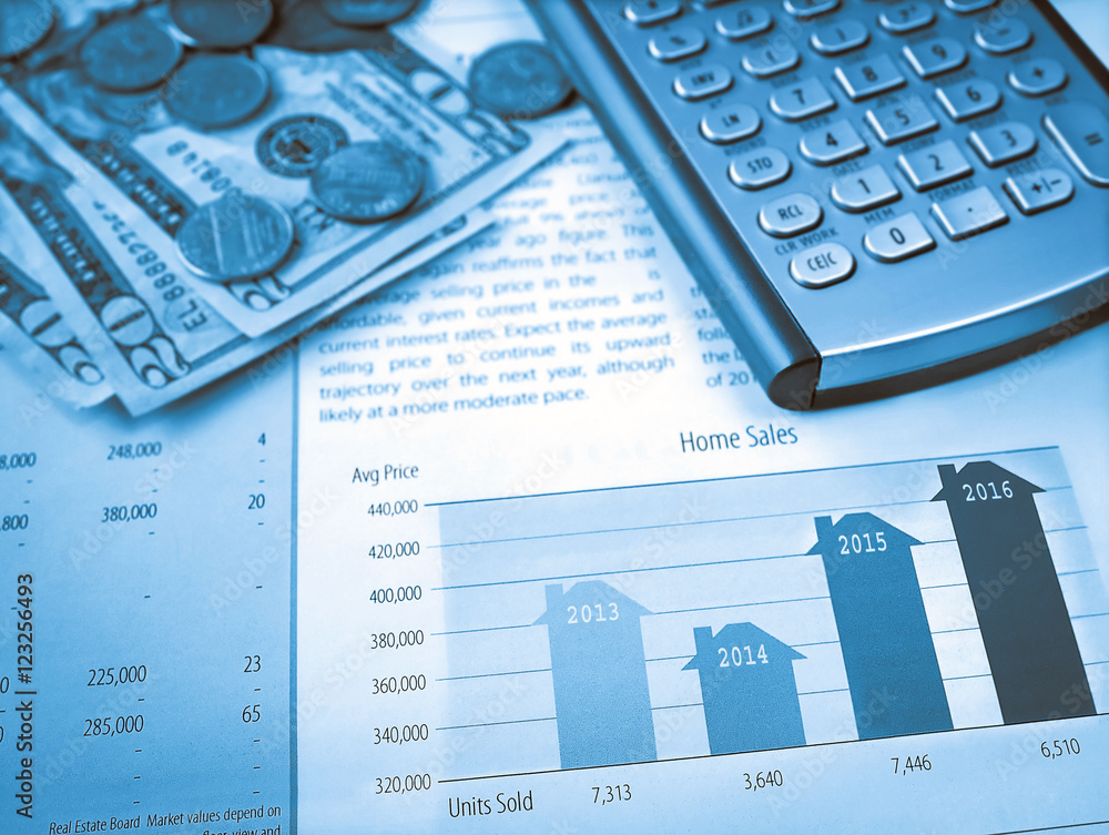 Money and calculator on the home sales chart Money and calculator on the home sales chart