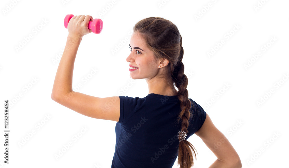 Smiling woman holding a pink dumbbell Smiling woman holding a pink dumbbell