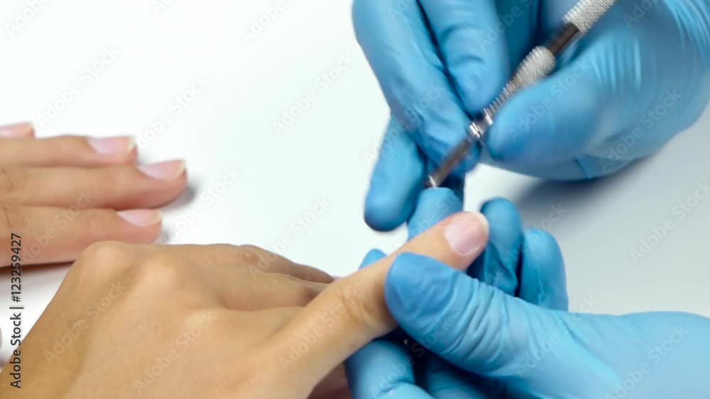 Manicure master is handles shovel each finger of client. Close up Manicure master is handles shovel each finger of client. Close up