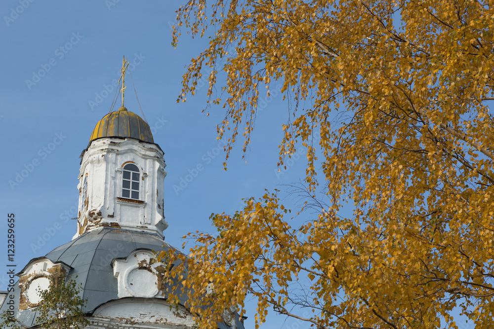 Autumn background - yellow dry leaves on the background of the old Church. Autumn background - yellow dry leaves on the background of the old Church.