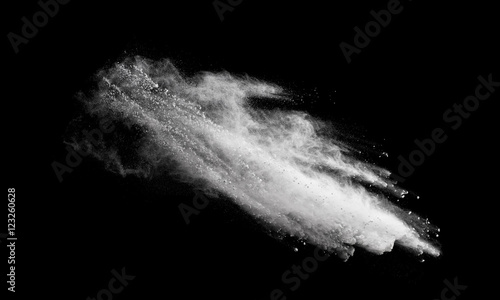 Freeze motion of white dust explosion isolated on black background