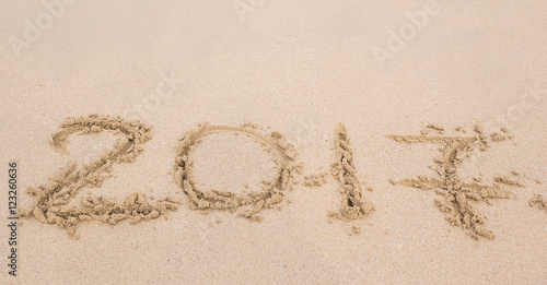 New Year 2017 is coming concept - inscription 2017 on a beach sand