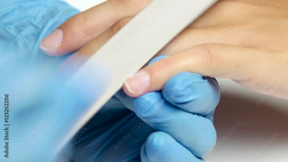 Manicurist makes the shape of nail by nail file. Close up Manicurist makes the shape of nail by nail file. Close up