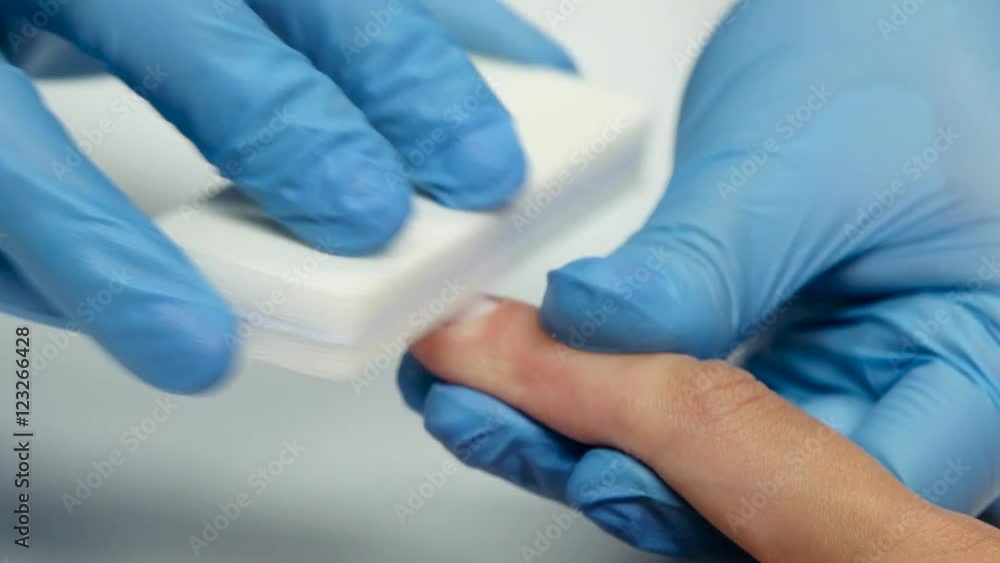 Manicurist handles nails of client by nail file. Close up Manicurist handles nails of client by nail file. Close up