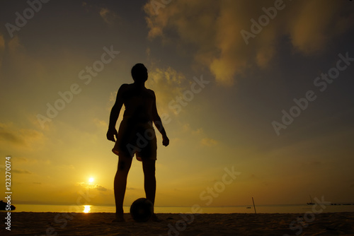 Fototapeta Naklejka Na Ścianę i Meble -  Silhouettes of soccer players during sunset.