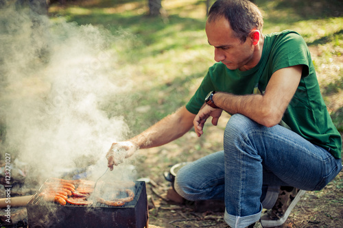 Man making barbecue in the park
