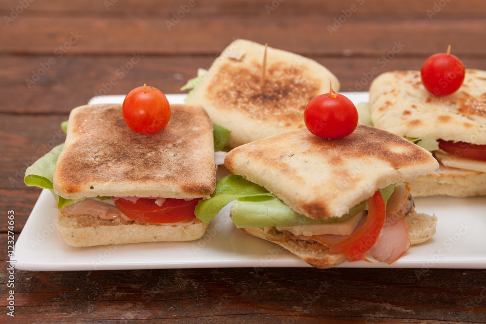 Small sandwiches with salmon, cheese and vegetables