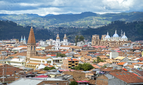 View of the city of Cuenca, Ecuador, with it's many churches and rooftops, on a cloudy day photo